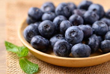 Blueberries on wooden plate, Healthy fruit, Food ingredient
