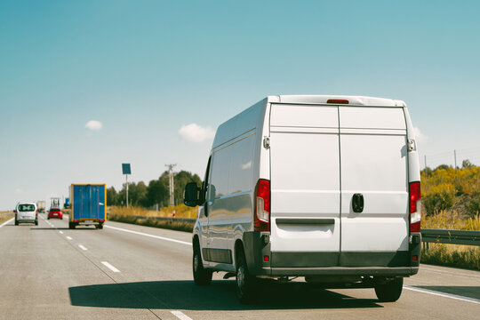 White van moving along rural highway