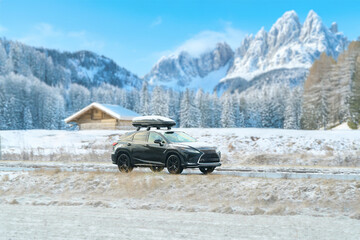 SUV on snowy dolomites during winter vacation