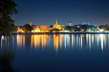 Obraz premium Serene Night View of Cityscape Reflected in Water with Illuminated Temples and Skylines Capturing the Essence of Urban Beauty and Tranquility at Dusk