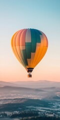Colorful Hot Air Balloon Soaring Over Serene Landscape at Sunrise