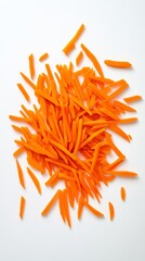 Pile of orange carrot slices on a white background. The slices are cut into thin strips and scattered across the surface. Concept of abundance and freshness