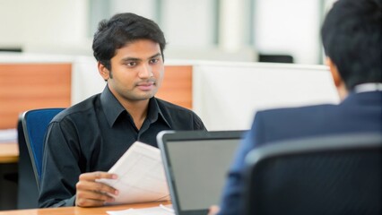 Obraz premium Indian HR Professional Managing Corporate Hiring Process - An Indian HR professional managing the recruitment and hiring process in an office. 