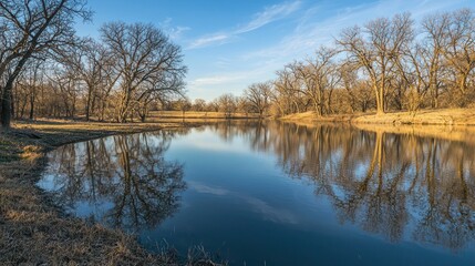 A smooth, still pond reflecting the surrounding landscape with no ripples disturbing the surface.