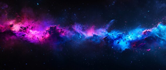 Colorful powder explosion creates a vibrant cosmic effect with blue and purple hues against a black...