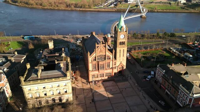 Aerial shot of the Guildhall and Peace Bridge in Derry-Londonderry, NI. The camera begins close and moves away from the building. Filmed in 4K at 60fps and in Rec709 color space.