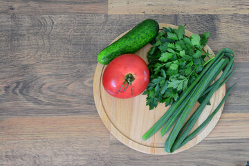 Fresh Vegetables on a Wooden Board tomato cucumber green onion parsley