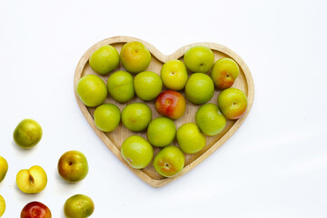 Fresh green plum fruit on white background.