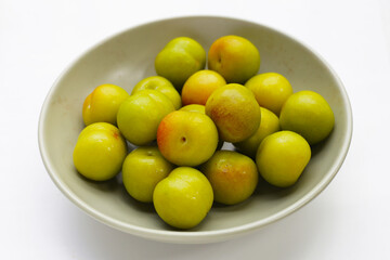 Fresh green plum fruit on white background.