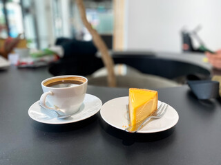 Cheesecake and hot americano coffee in a cafe