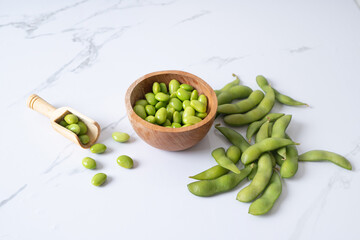 fresh edamame in wooden bowl