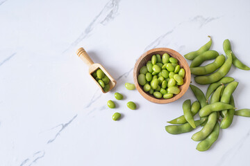 fresh edamame in wooden bowl