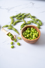 fresh edamame in wooden bowl