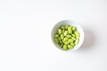Edamame beans in white bowl