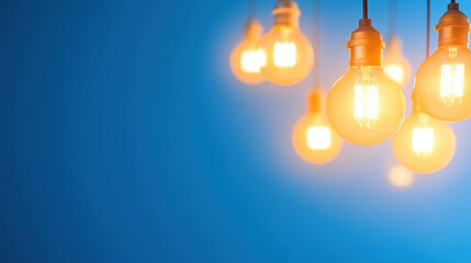 Glowing incandescent light bulbs against a blue background