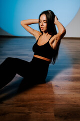Fototapeta premium Fitness enthusiast practicing core exercises in a well-lit studio during a fitness session