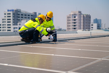 The technician Inspecting Solar Panels on a Factory Roof. An engineer wearing safety gear...