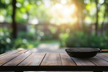Outdoor grill pan on wooden table, sunny garden background, food presentation