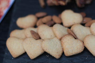 Delicious cookies arranged beautifully on a light background, perfect for Valentine's Day celebrations, romantic gifts, or festive treats. Valentines day background with cookies in shape of heart. 