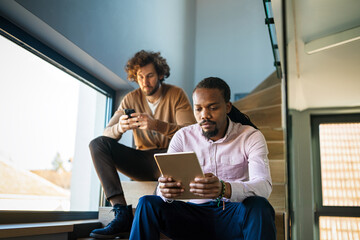 Diverse business people wear face mask to keep social distancing as new normal working in office