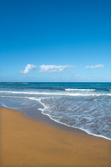Cyprus Alagadi Turtle Beach. View from the beach to the sea. Magnificent beach, sea and blue cloudy sky. Yellow sand beach. Beach and blue sky.