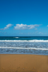 Cyprus Alagadi Turtle Beach. View from the beach to the sea. Magnificent beach, sea and blue cloudy sky. Yellow sand beach. Beach and blue sky.