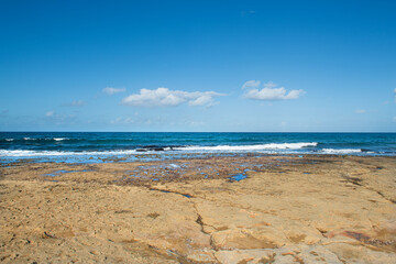 Cyprus Alagadi Turtle Beach. View from the beach to the sea. Magnificent beach, sea and blue cloudy sky. Yellow sand beach. Beach and blue sky.