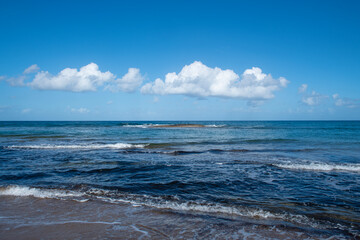 Cyprus Alagadi Turtle Beach. View from the beach to the sea. Magnificent beach, sea and blue cloudy sky. Yellow sand beach. Beach and blue sky.
