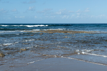 Cyprus Alagadi Turtle Beach. View from the beach to the sea. Magnificent beach, sea and blue cloudy sky. Yellow sand beach. Beach and blue sky.