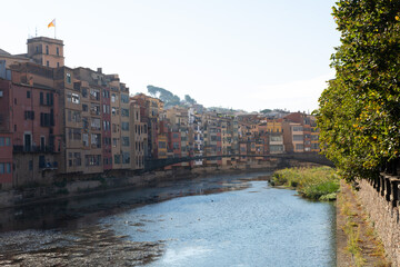 Colorful houses reflecting in the onyar river in girona, catalonia