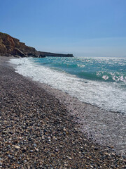 Seascape with pebble beach and turquoise sea