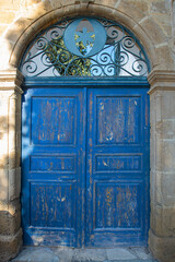 Old historical colorful doors and shutters made of wrought iron and wood. Old historical wooden doors in Cyprus. Doors and shutters of historical stone houses in Nicosia.	