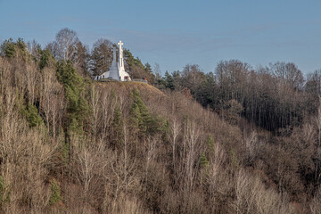 The Three Crosses Monument on the forested Hill in Kalny Park, as seen from Gediminas Hill in the Old Town of Vilnius, Vilnius, Lithuania