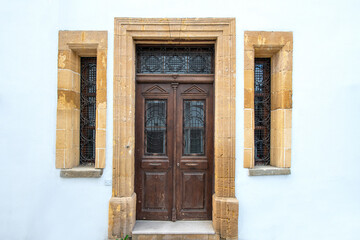 Old historical colorful doors and shutters made of wrought iron and wood. Old historical wooden doors in Cyprus. Doors and shutters of historical stone houses in Nicosia.	