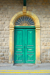 Old historical colorful doors and shutters made of wrought iron and wood. Old historical wooden doors in Cyprus. Doors and shutters of historical stone houses in Nicosia.	