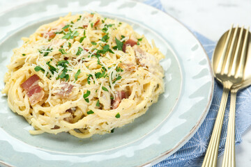 Delicious pasta Carbonara with bacon served on table, closeup