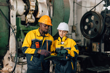 professional engineer team inspecting service machine in heavy industry factory