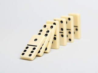 Domino effect. Tiles falling on light background