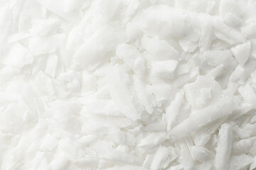 White soy wax flakes as background, closeup