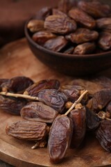 Tasty dried dates on wooden table, closeup