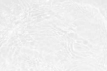White water with ripples on the surface. Defocus blurred transparent white colored clear calm water surface texture with splashes and bubbles. Water waves with shining pattern texture background.