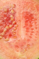 Fototapeta premium Juicy guava fruit with seeds as background, top view