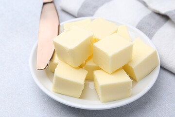 Pieces of fresh butter on white table, closeup