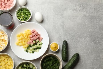 Different ingredients for okroshka soup on grey table, flat lay. Space for text