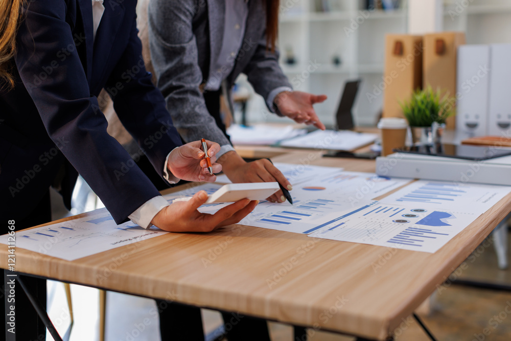 Wall mural Financial Business two women analyze the graph of the company's performance to create profits and growth, Market research reports and income statistics, Financial and Accounting concept.	
