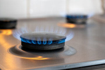 Natural Gas. High prices of natural gas. Blue flames of gas burning from a kitchen gas stove burner