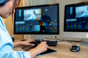 A freelance graphic designer working on video editing at home