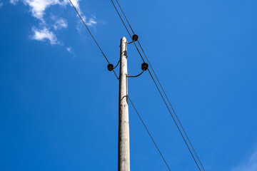 Wooden pole with power lines