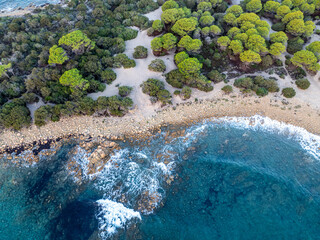 Aerial view ocean waves on remote and wild sandy beach in Italy. Background texture of water, waves and beach.	