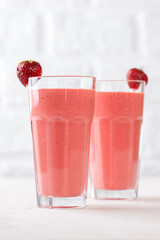 Strawberry cocktail, smoothie from strawberries, coconut cream, green buckwheat in glasses. Lactose and sugar free. Vertical orientation.